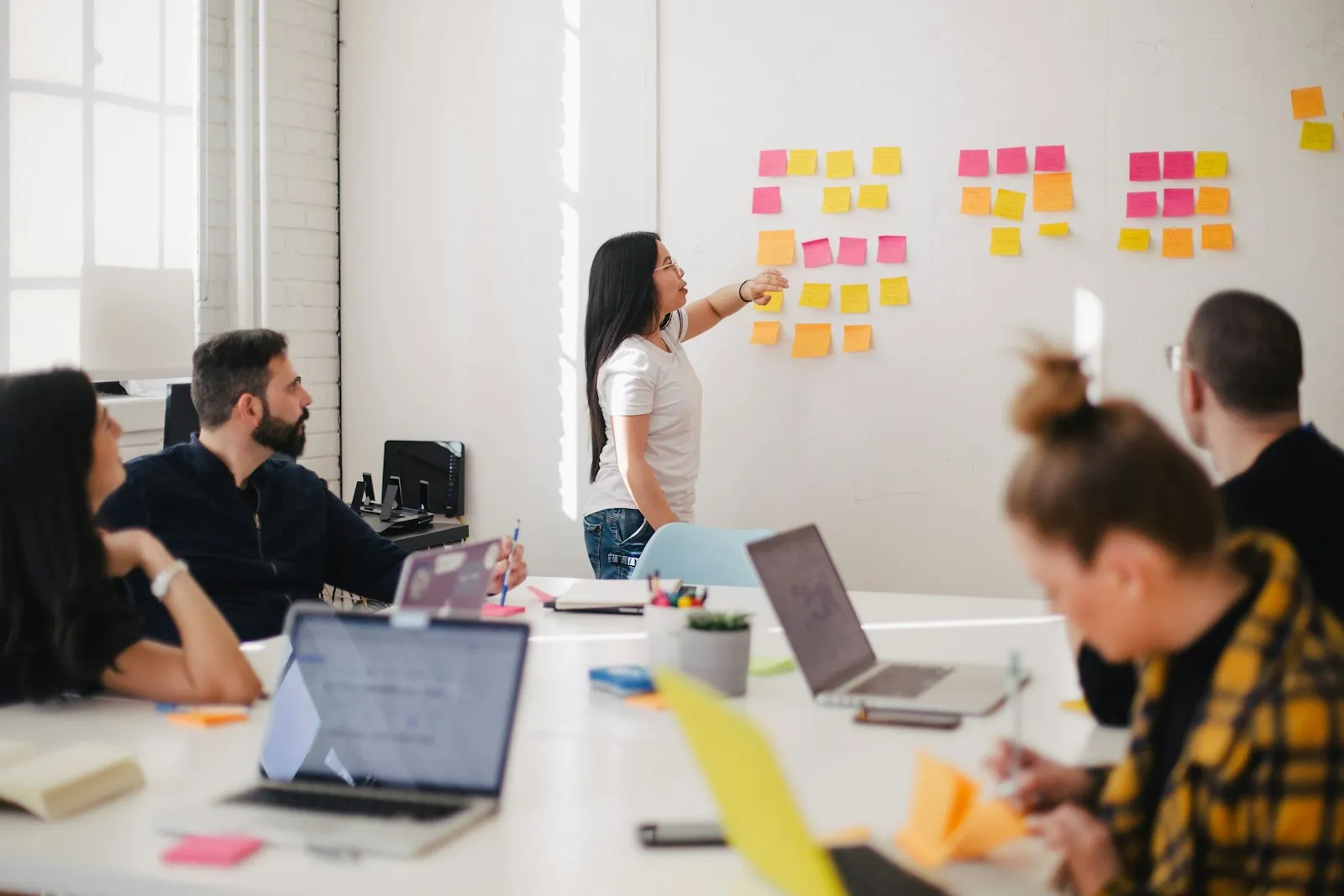 Consultants collaborating around a table on a digital strategy